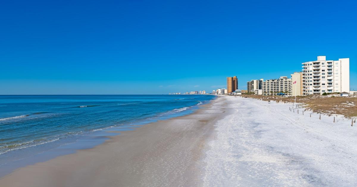 Oceanfront condos and homes along the white sandy shoreline, ideal for Panama City Beach condo rentals with direct beach access and stunning Gulf views.