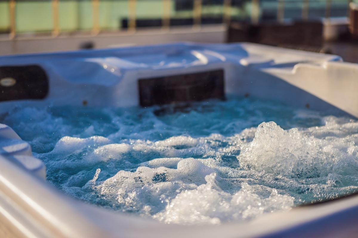 Close-up of a bubbling hot tub at a coastal property, showcasing the relaxing amenities offered by Panama City Beach rentals with hot tub access.
